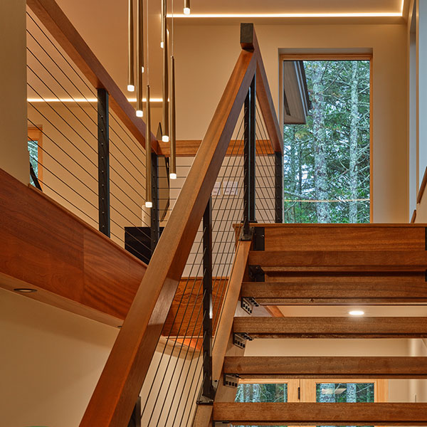 Custom beam wraps and header boards in Sapele to match open stairs