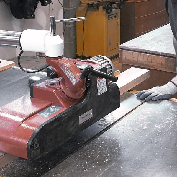 Precision ripping an 8 /4 board using a power feeder and industrial table saw