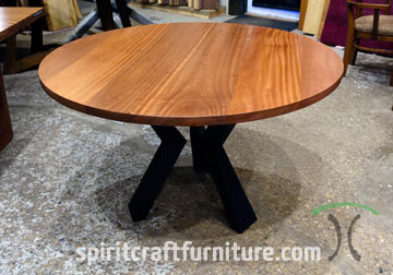 Sapele Ribbonstripe Mahogany Round Dining Table with Steel Knee Legs by Spiritcraft Furniture in East Dundee, Illinois.