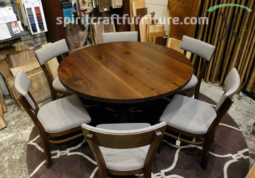 Round Black Walnut dining table with custom 3x3 hourglass base for Chicago area client by Spiritcraft Furniture in East Dundee, Illinois.