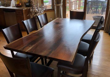 Solid hardwood live edge dining table from slabs of kiln dried Black Walnut with RH Yoder chairs at Spiritcraft Design Furniture in East Dundee, Illinois