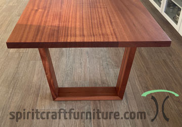 Ribbonstripe Sapele Mahogany Dining Table with Solid Wood Mitered Trapezoid Legs, Set Up in Chicago Area Home.