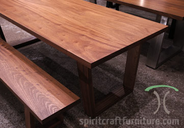 Thick slab dining or conference table in Sapele Mahogany with matching slab bench on solid hardwood trapezoid mid century modern style legs available at Spiritcraft Furniture, Dundee, IL